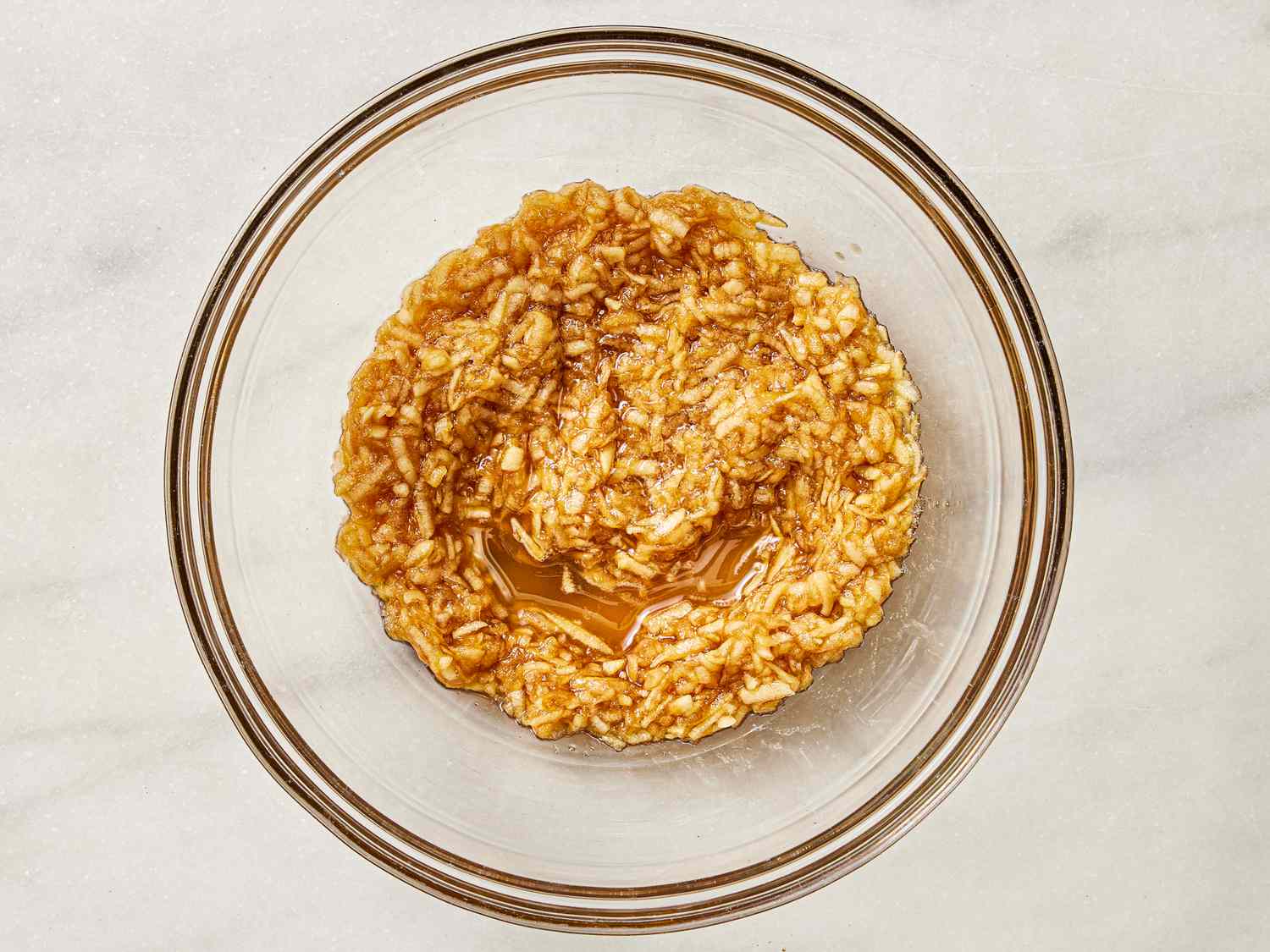 Apples and brown sugar in medium bowl