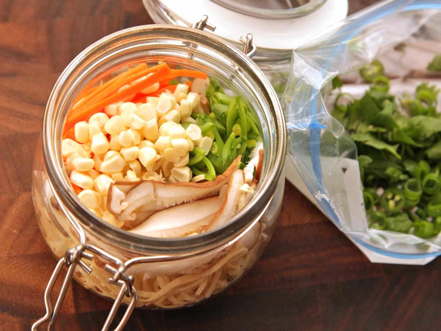 A full flip top jar of homemade instant noodles and an accompanying flavor pack.