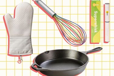 A collection of kitchen tools including a white oven mitt a black skillet a multicolored whisk and a packaging labeled Superwhisk