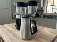 The OXO Brew 9-Cup Coffee Maker on a wooden surface in a kitchen.