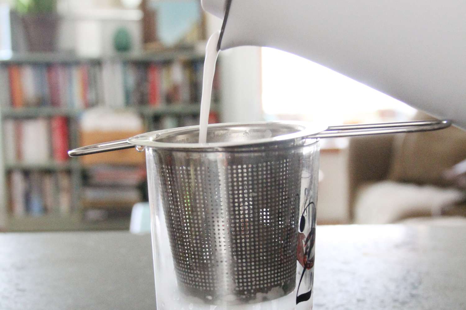 pouring milk through the filter to see if any bits remain