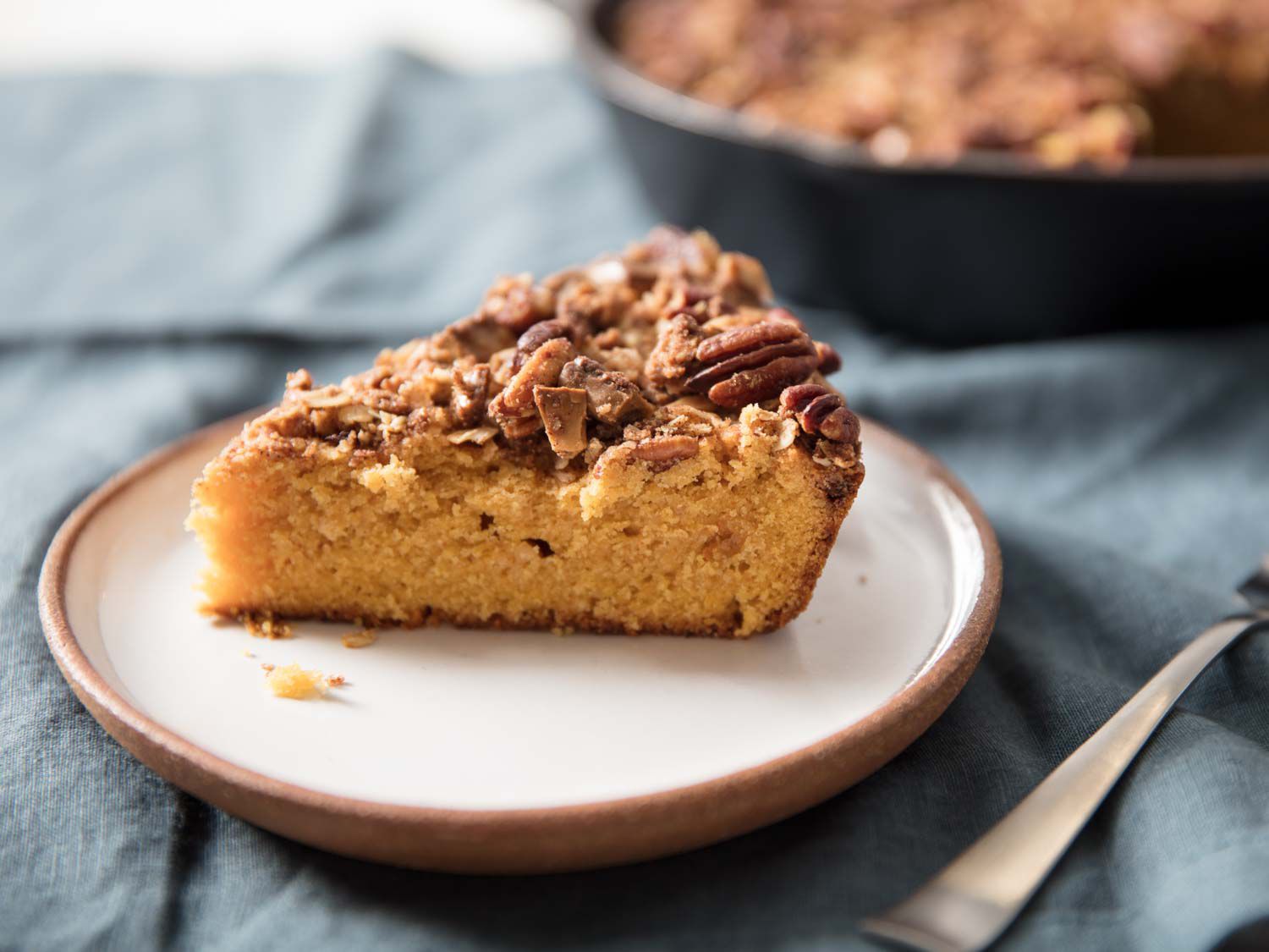 A wedge of pumpkin skillet coffee cake on a plate