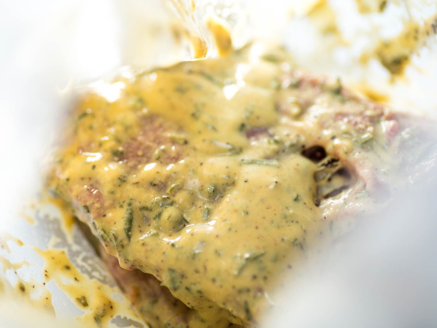 Closeup of Dijon mustard marinade-slathered skirt steak.