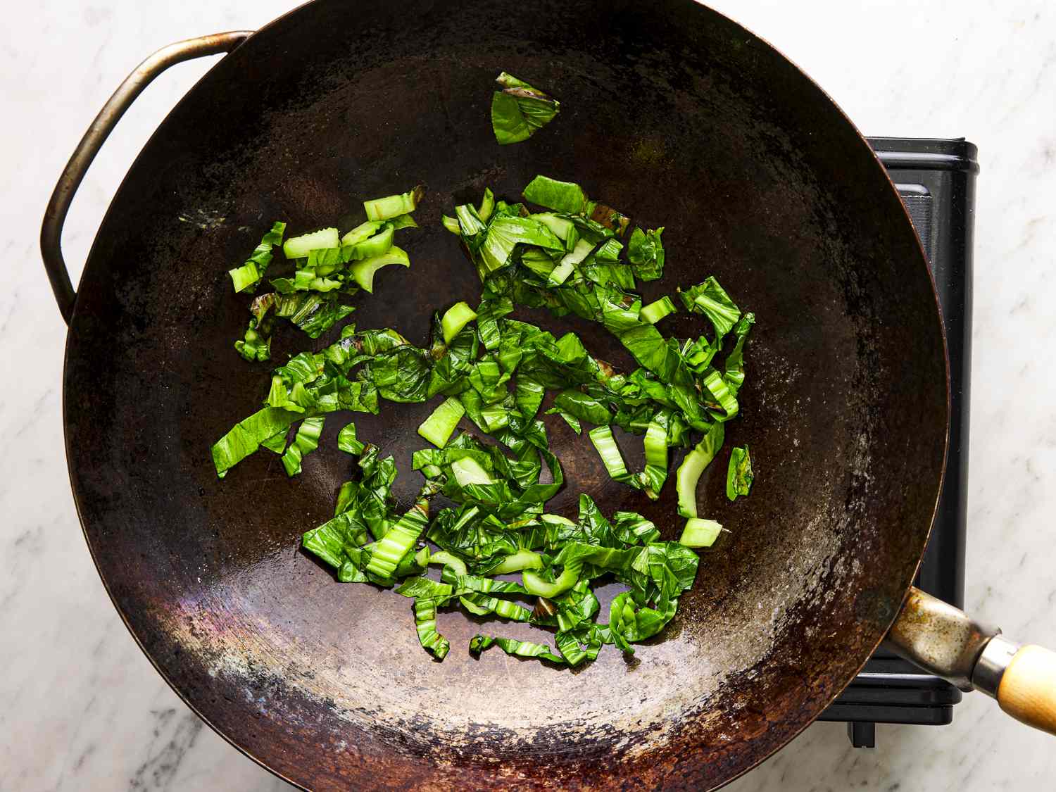 Greens cooking in wok