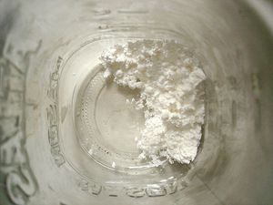 The bottom of a glass jar filled with cornstarch