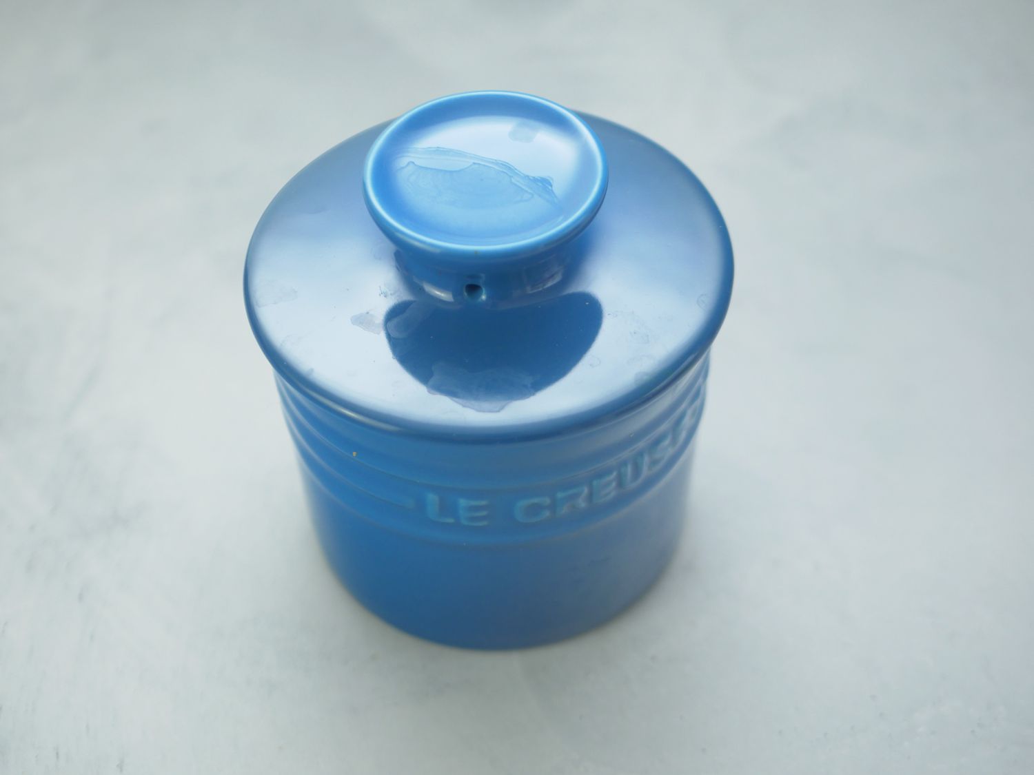 the le creuset butter crock with the lid on 