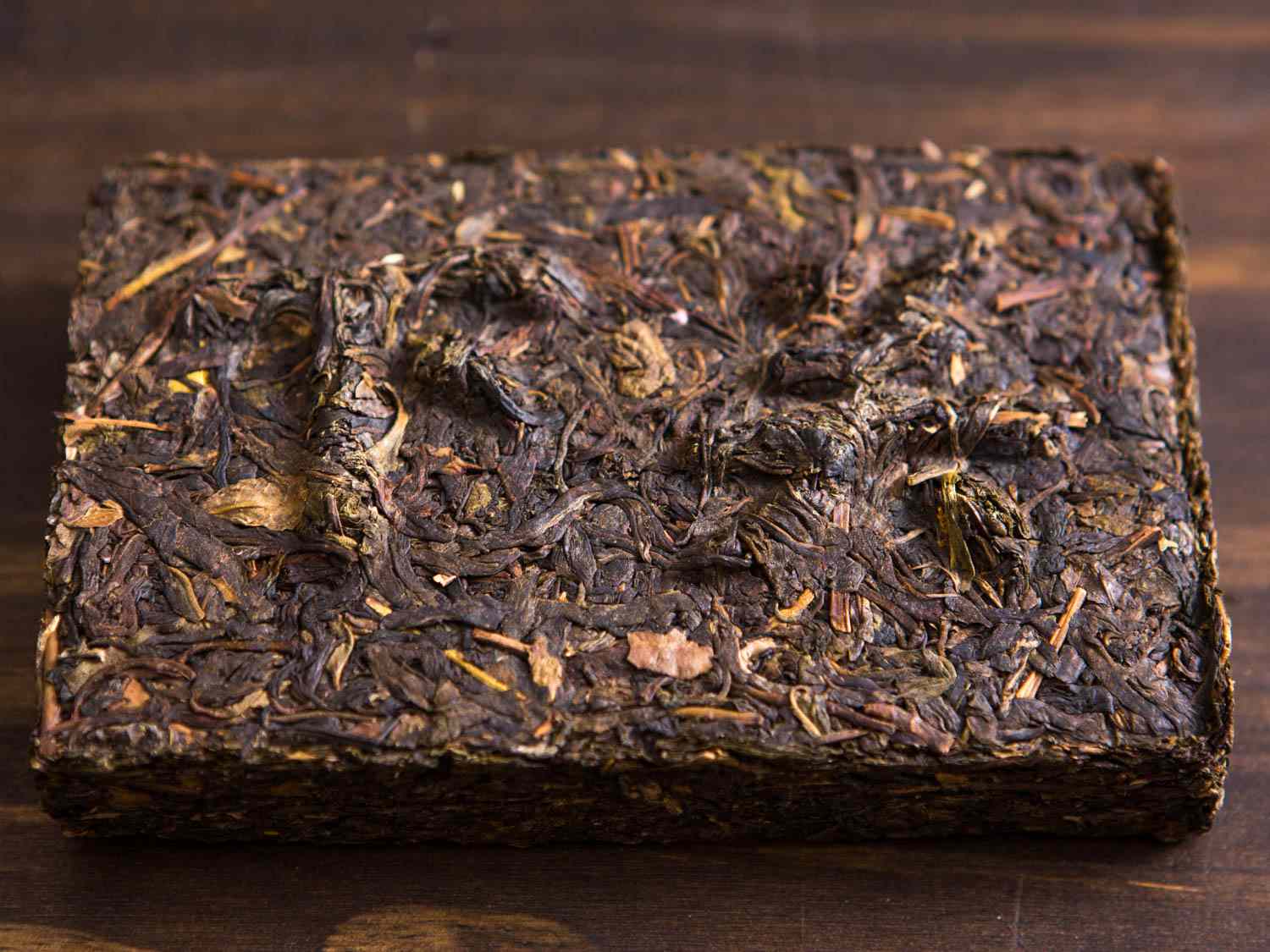 Pu-erh tea in a compressed brick with raised Chinese characters 