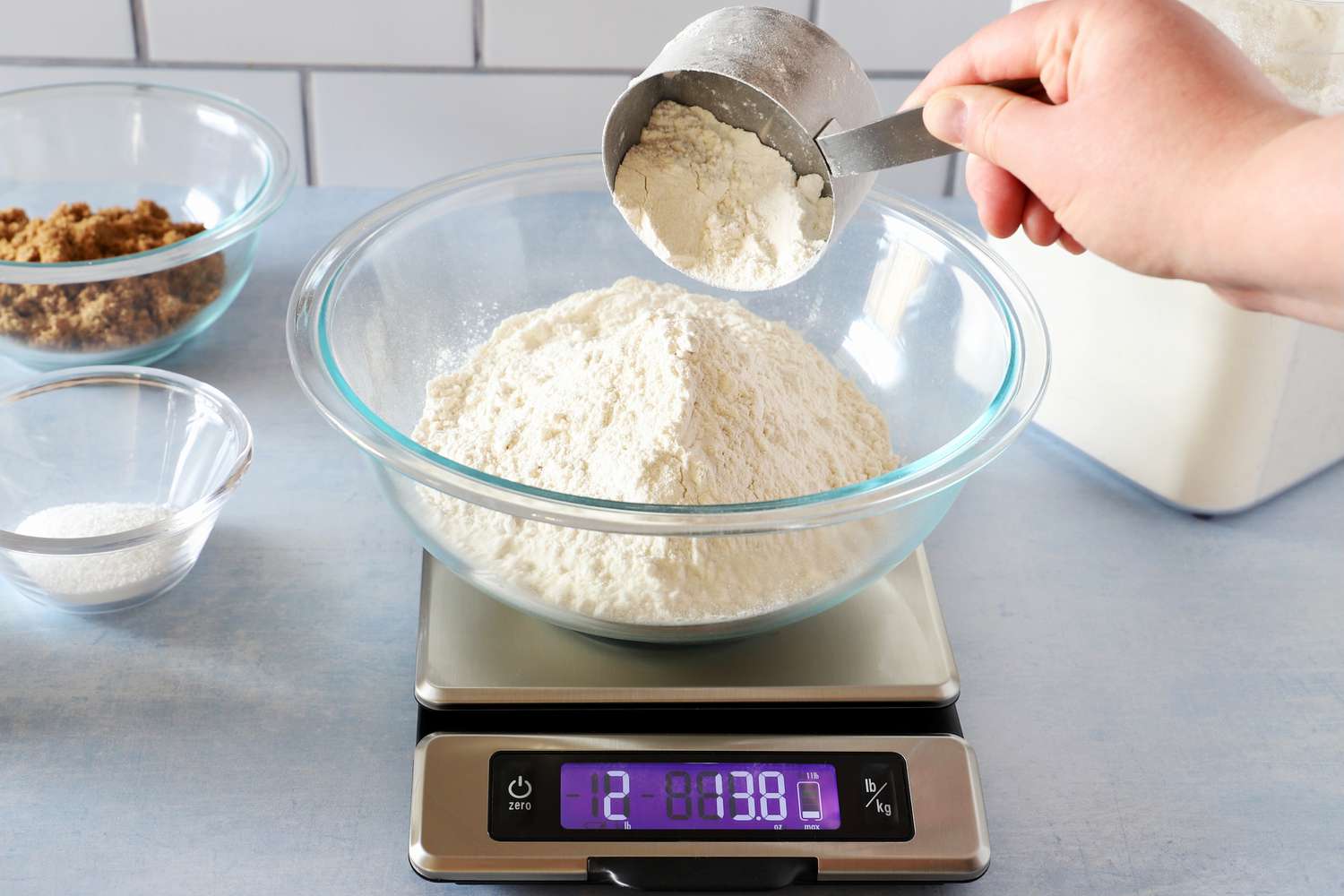 Flour added to a bowl on a kitchen scale