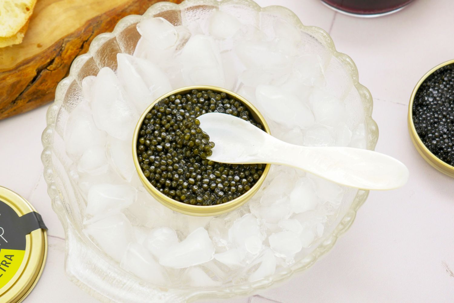 Caviar in a tin surrounded by ice with a small spoon