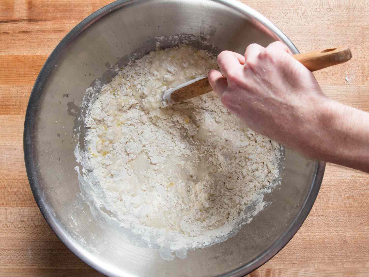 Overhead shot of mixing dough for pan pizza.