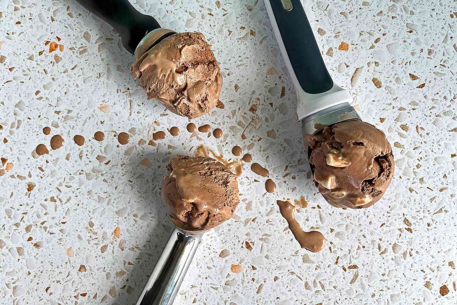 three ice cream scoops with ice cream inside