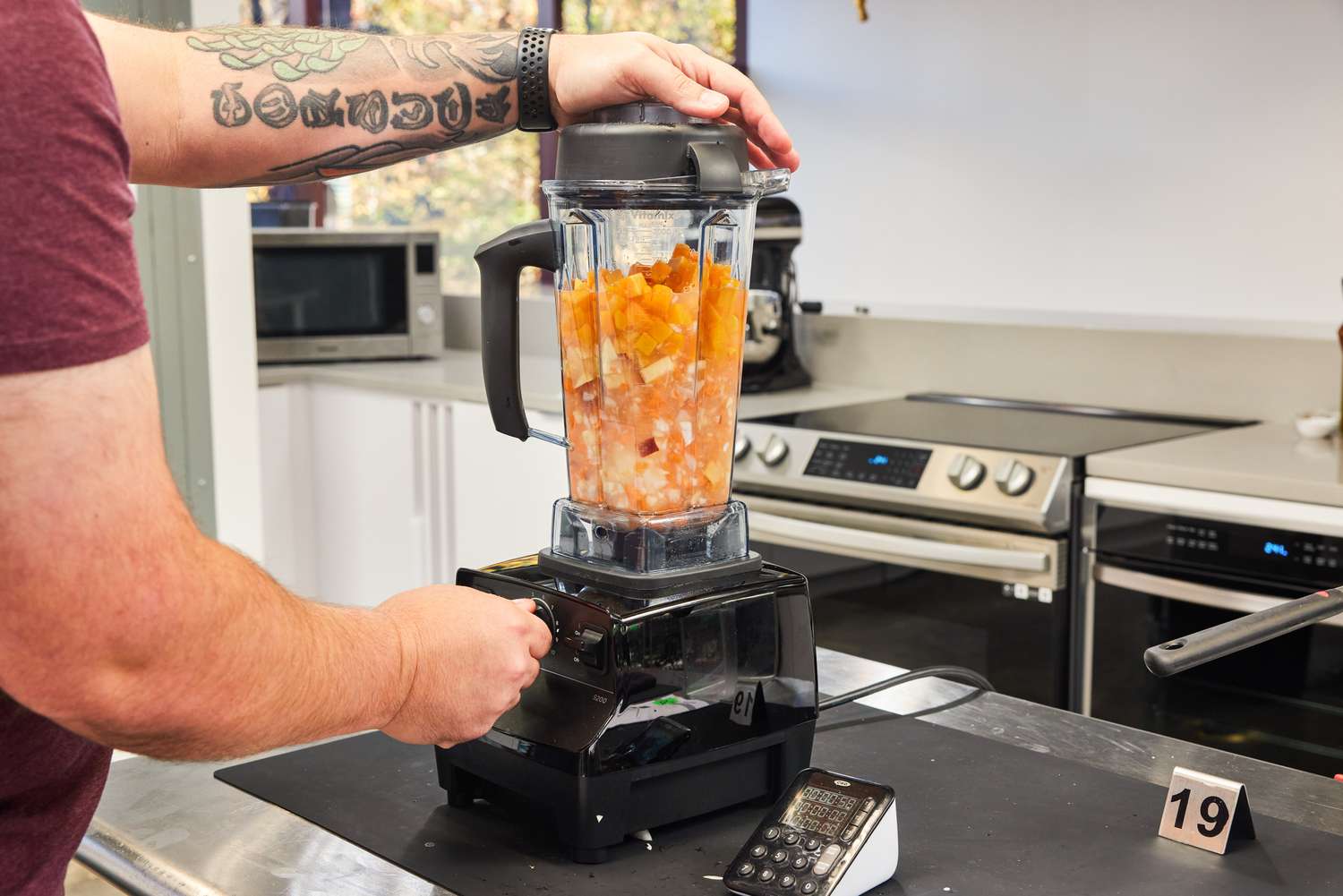 Person blending fruit and vegetables in the Vitamix 5200 Professional-Grade Blender