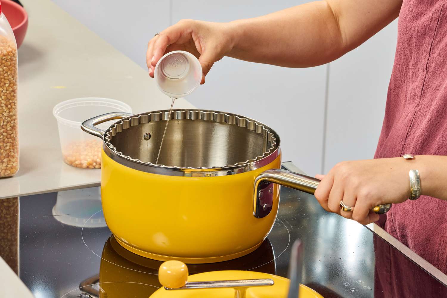 A person pours butter into the Popsmith The Popper