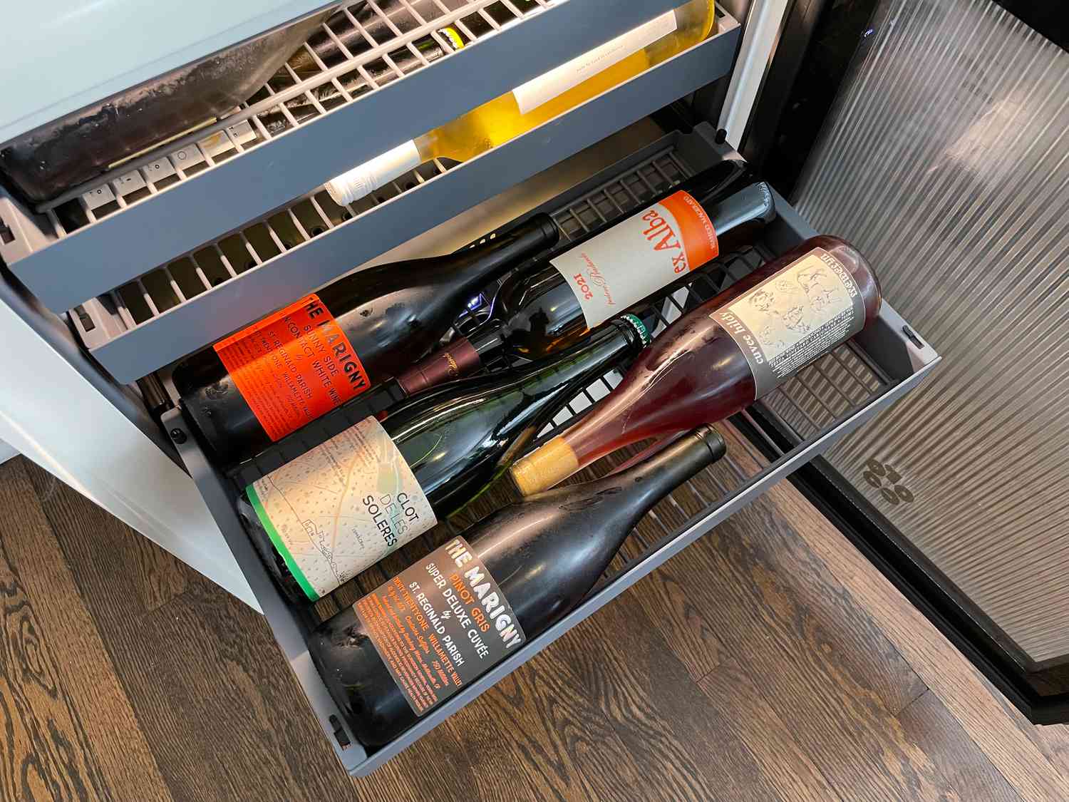 one of the shelves in the rocco wine fridge pulled out showing five bottles of wine