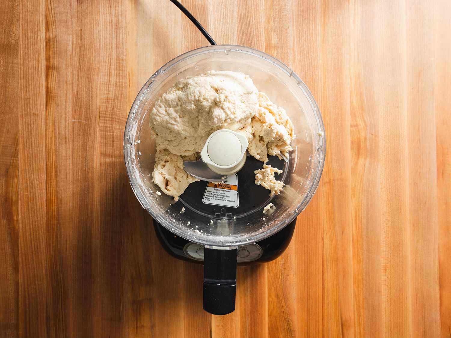 Pizza dough after just coming together in a food processor