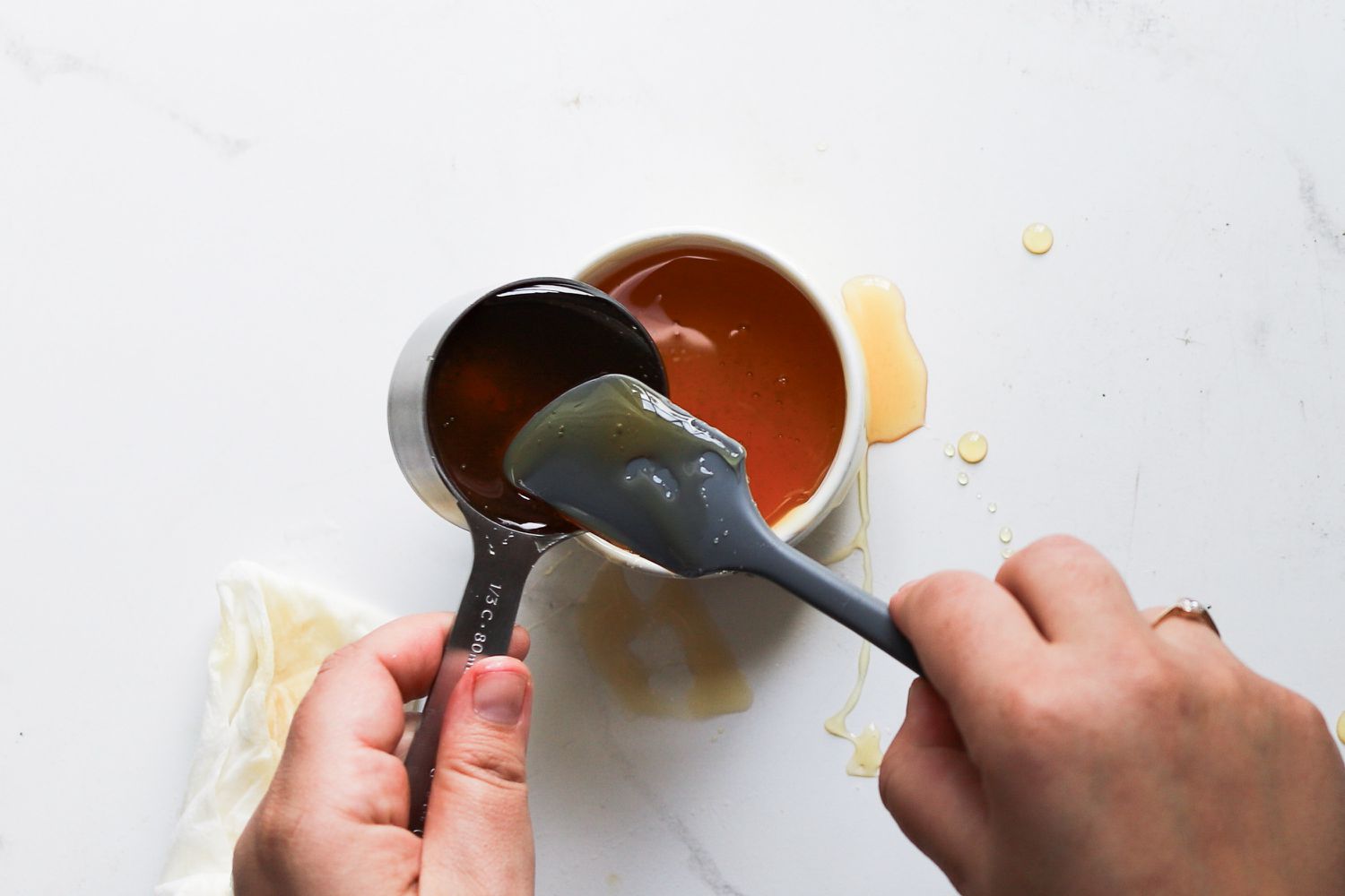 Scraping honey from Sur La Table Stainless Steel Measuring Cup