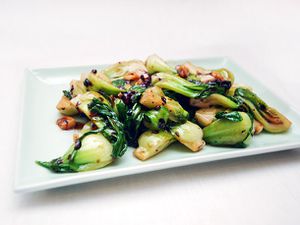 Shanghai baby bok choy with black bean sauce on a square white plate. 