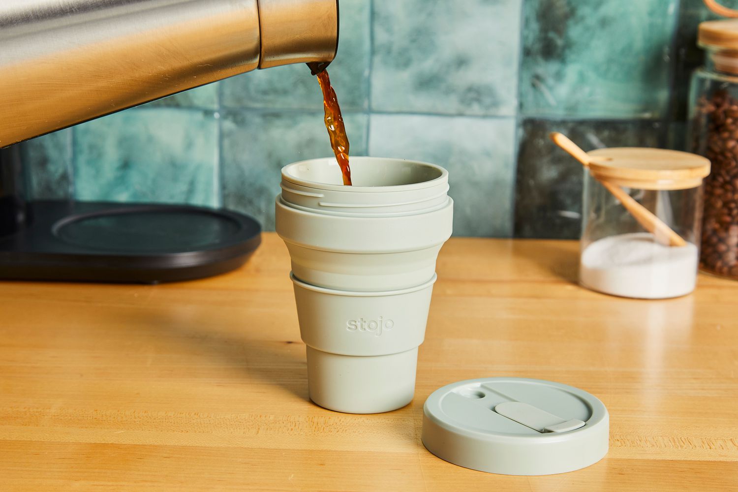 Coffee being poured into a Stojo travel cup.