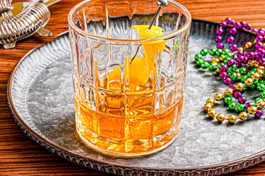 Overhead view of a Sazerac with Mardi Gras beads