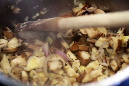 Stirring chopped mushrooms and shallots for scallop pot pies