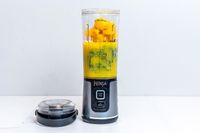 Fruit and vegetables inside the Ninja Blast Portable Blender with the lid open