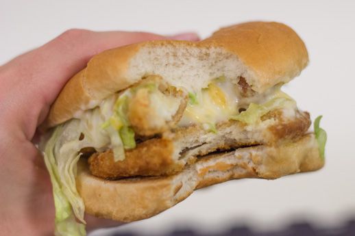 An Exploding Cheesy Chicken sandwich with bites taken out of it.