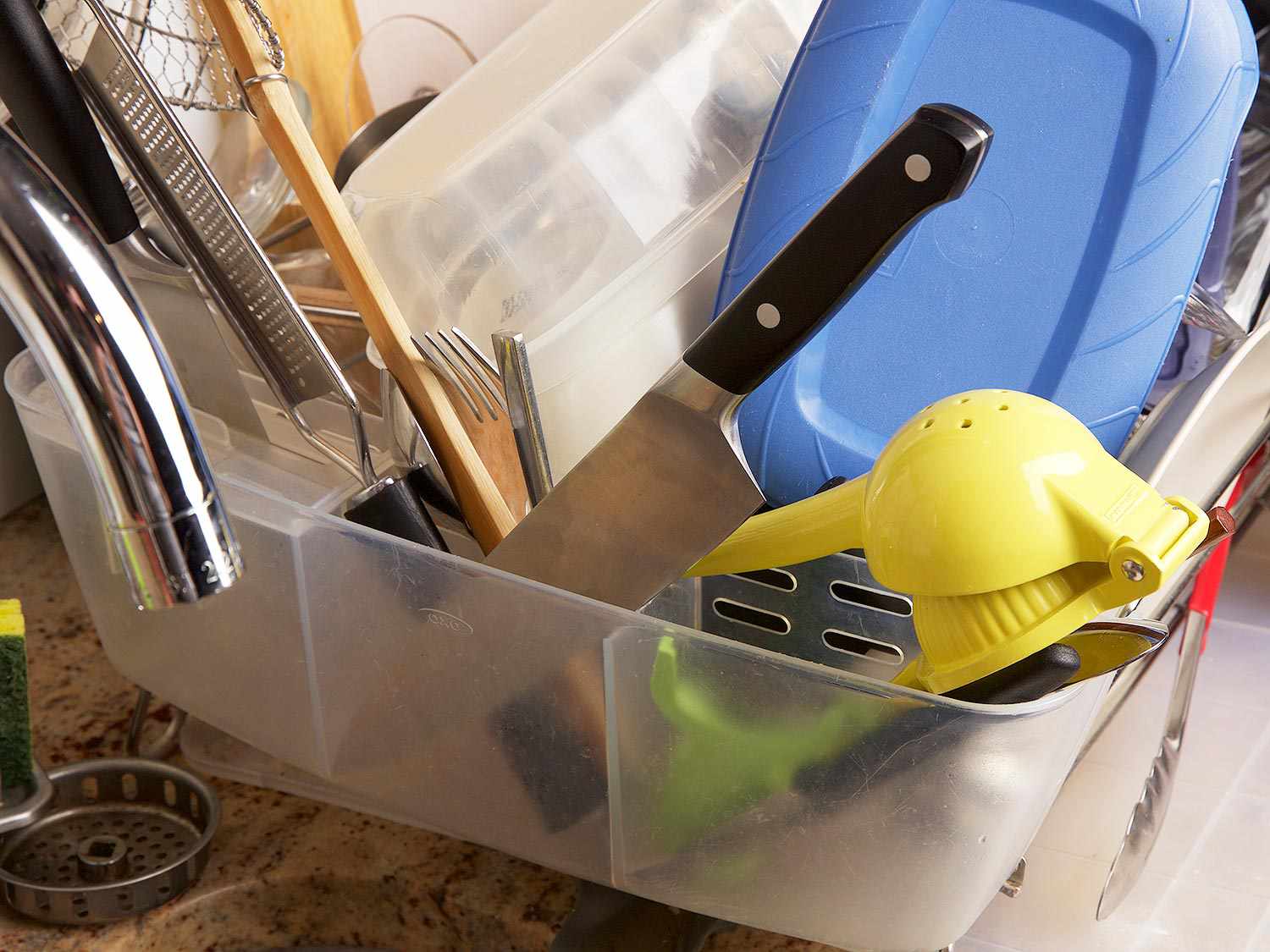 A knife in a dish rack's utensil holder