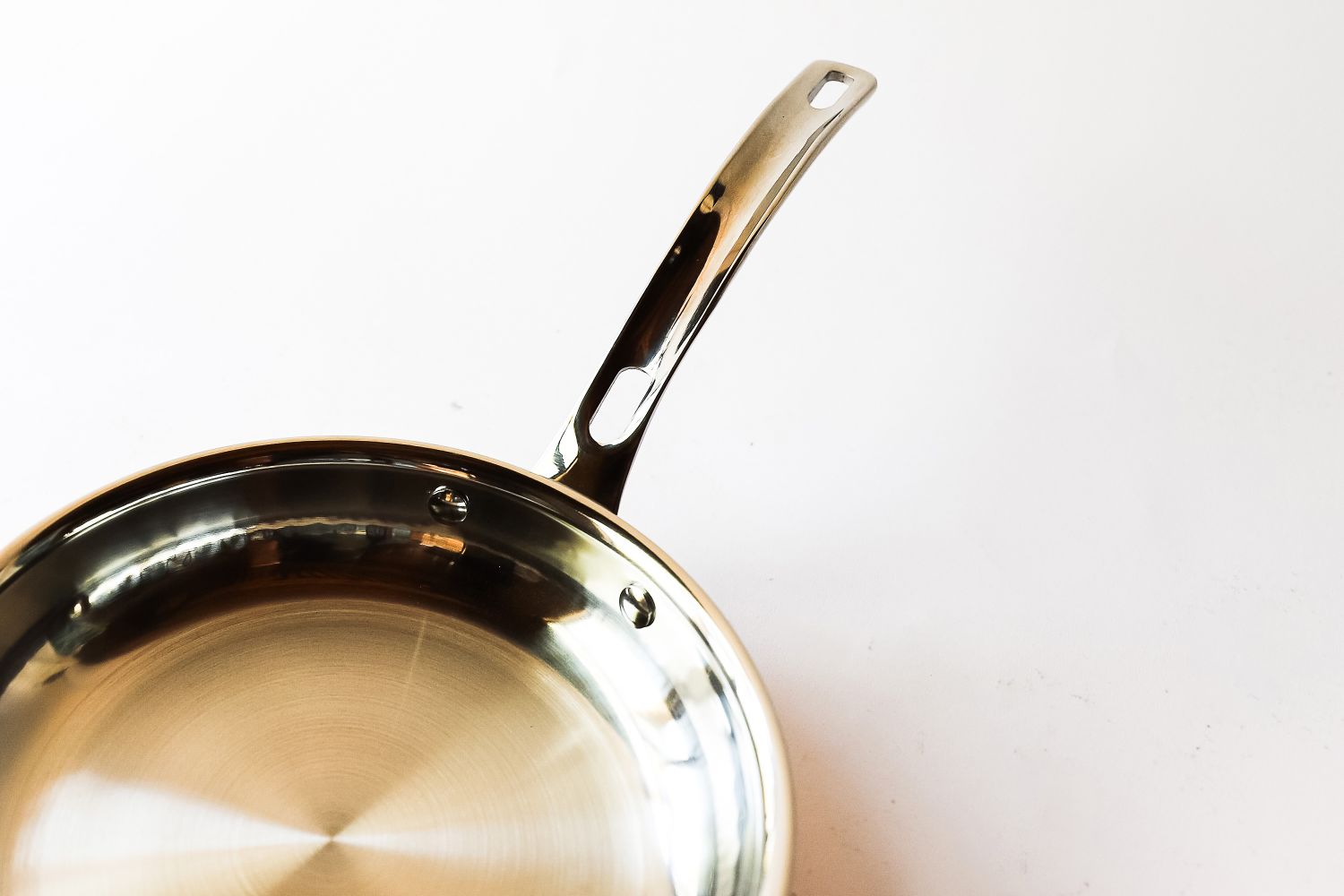 A closeup view of a metallic frying pan with a shiny surface