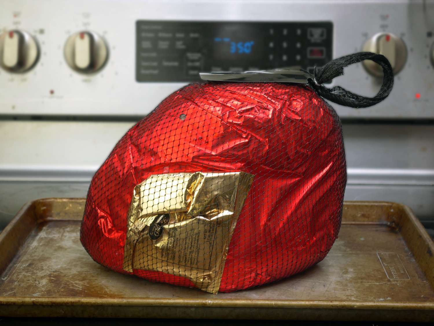 a wrapped ham on a sheet tray