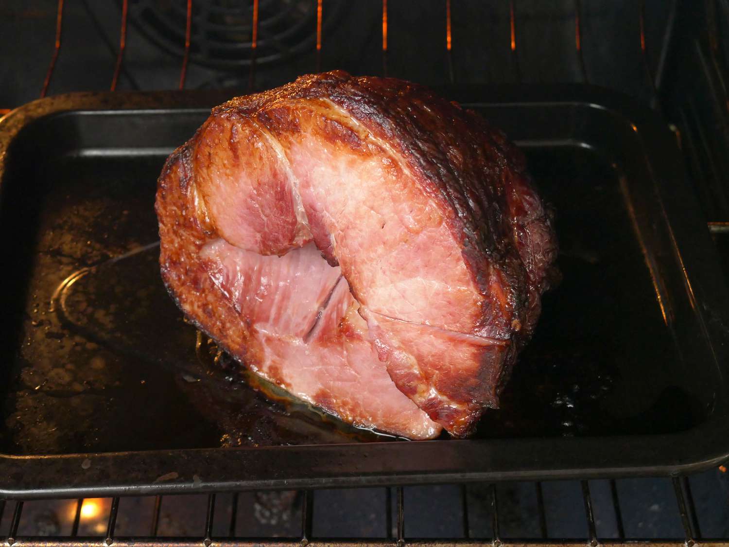 snake river farm ham on a sheet tray roasting in the oven