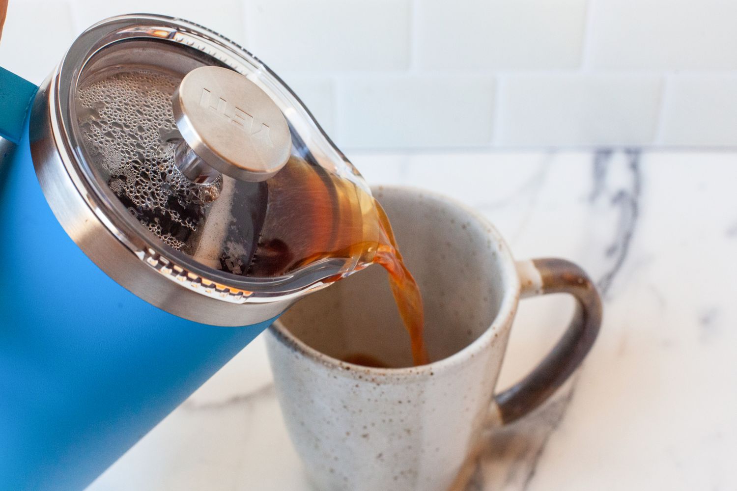 Coffee being poured from the Yeti French Press into a mug