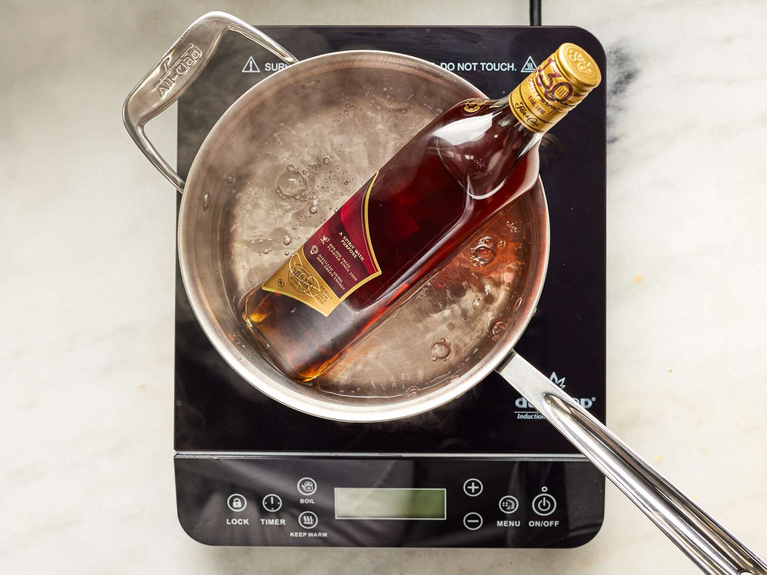 Overhead view of heating a bottle of rum