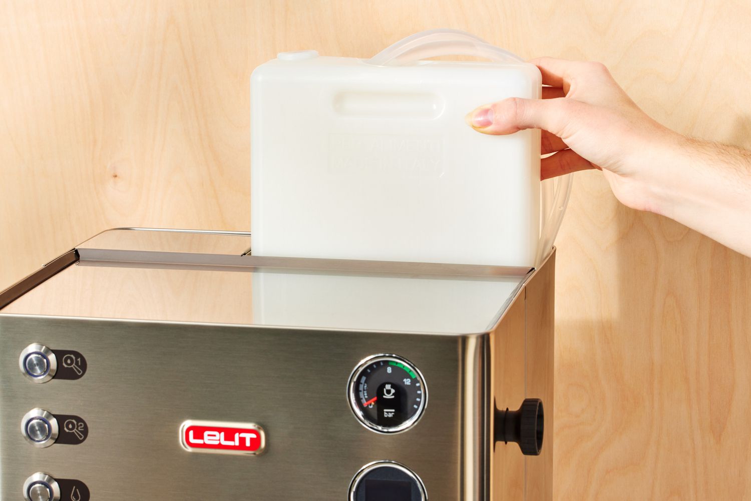 A person adjusting one part of the Lelit Elizabeth Espresso Machine