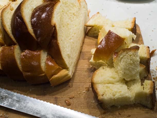 Cutting up chunks of stale challah bread.