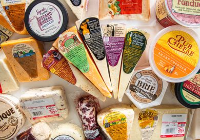 Variety of packaged cheeses displayed together sourced from Trader Joes