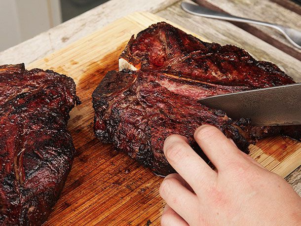 Author cutting into one of the porterhouses, separating the tenderloin from the T bone.