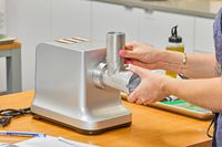 Person fixing grinder body of Weston #12 Electric Meat Grinder & Sausage Stuffer