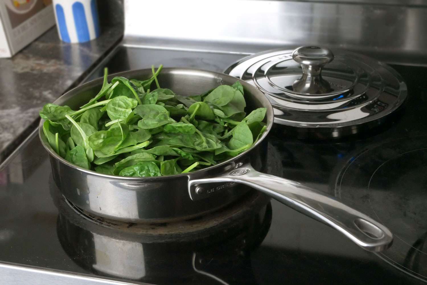 Spinach Cooking in the Le Creuset Signature Stainless Steel Saute Pan