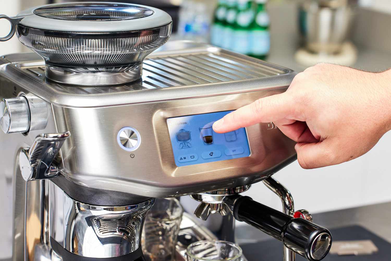 A person using the touchscreen on the Breville Barista Touch Impress Espresso Machine with Grinder