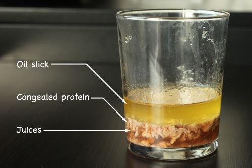 Labeled photo of cup of juice, showing division between oil, juice, and congealed protein.