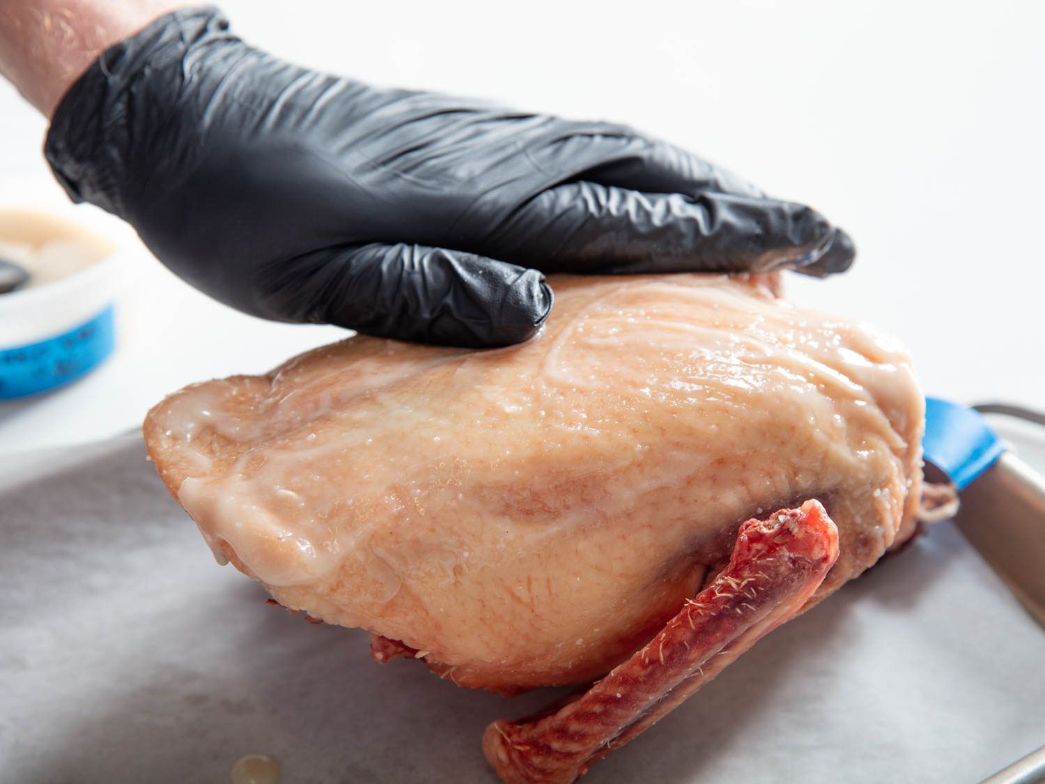 Rubbing blended shio koji over surface of duck crown.