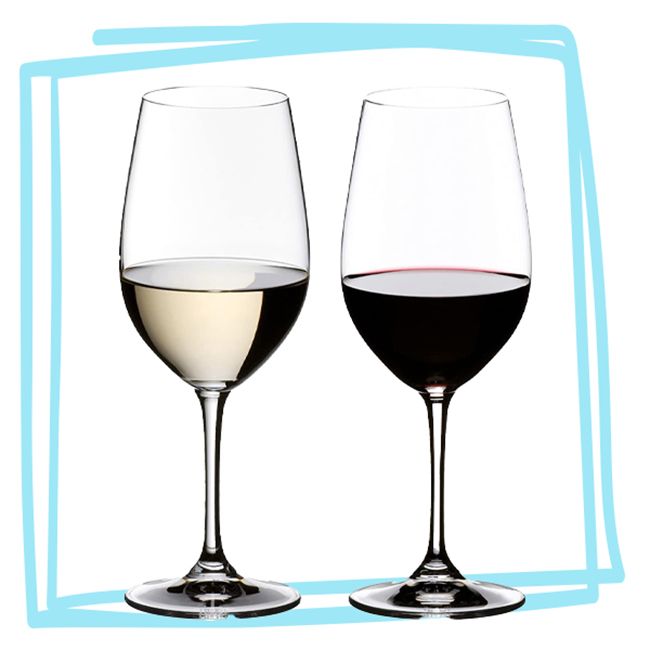 Two wine glasses one filled with white wine and the other with red wine placed side by side
