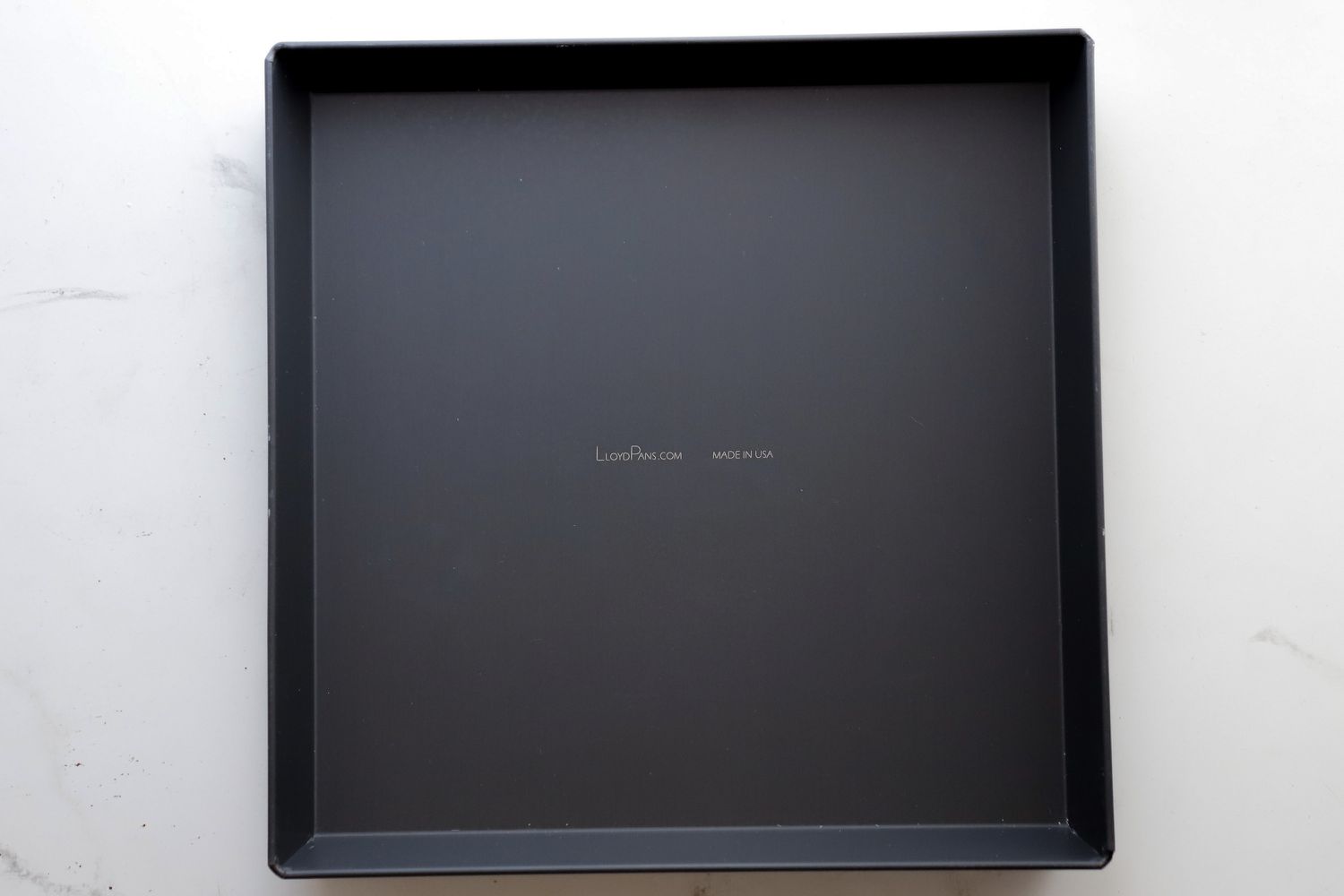 An empty LloydPans 12x12x1.5 inch Sicilian Style Pizza Pan