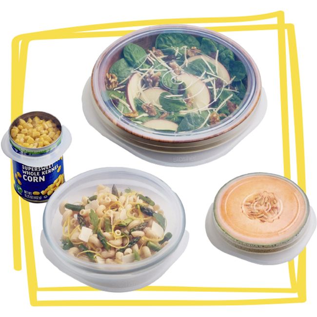 A set of food containers sealed with silicone stretch lids containing various foods