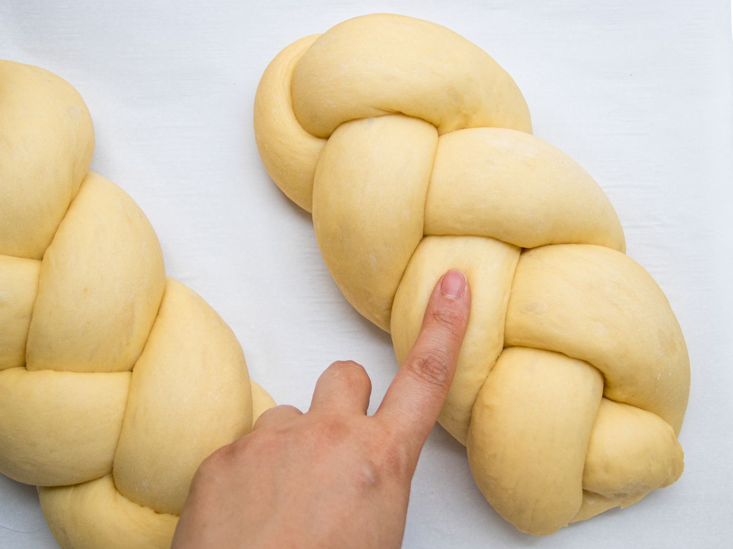 pressing finger onto loaf to test proofing