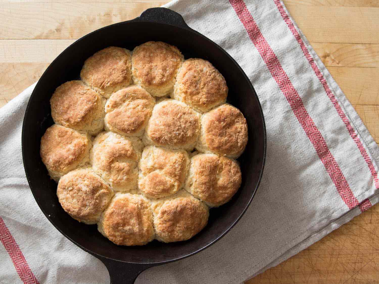Overhead shot of baked yogurt biscuits in a cast-iron skillet.