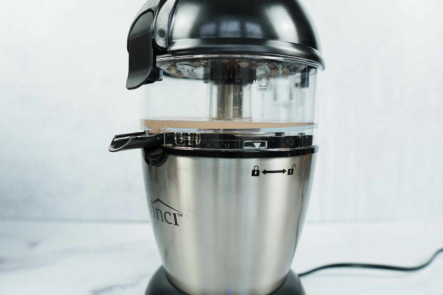 A closeup look at the Vinci electric citrus juicer juicing a grapefruit half