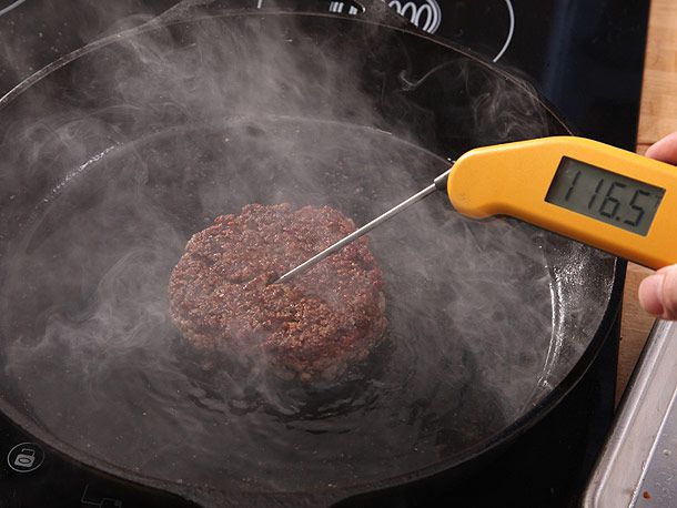 checking burger patty with meat thermometer