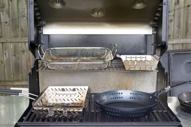 grill baskets on an open gas grill