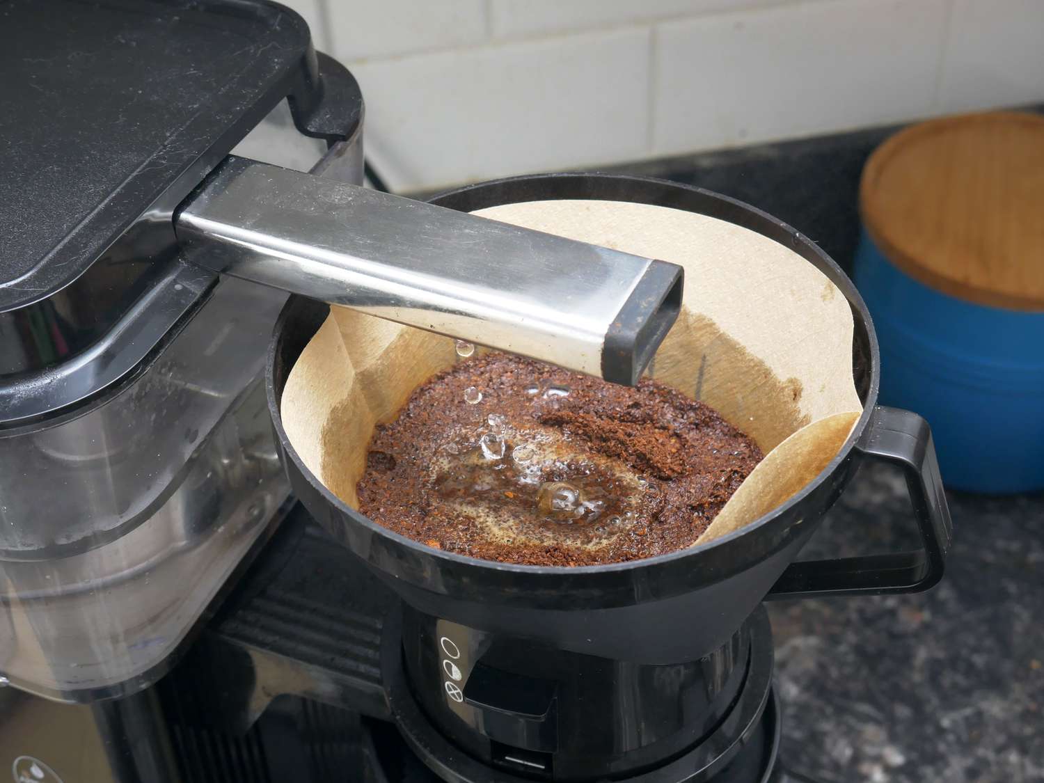 an overhead view of the moccamaster brew head spraying water into the basket with grounds